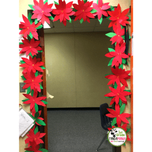 This poinsettia craft was hand-drawn by one of our teacher's mothers and has become our most talked about classroom door Christmas idea year after year!